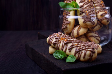 Shortbread cookie sticks with chocolate glazing against the dark background