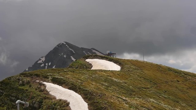Moving fast clouds at the panorama of top of roza khutor mountains