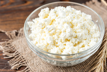 Cottage cheese on wooden background.