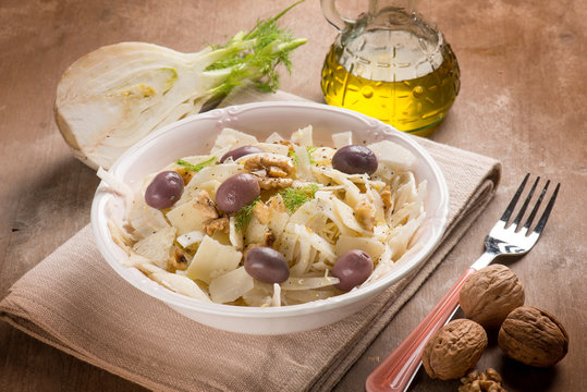 fennel salad with parmesan cheese flakes black olives and nuts