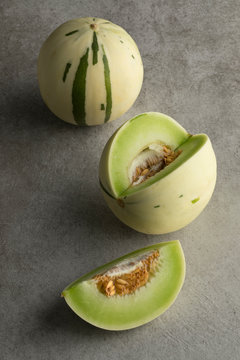 Whole and cut white honeydew melons
