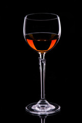 A glass of sweet wine on a dark background