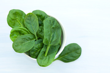 Fresh spinach leaves in a bowl.