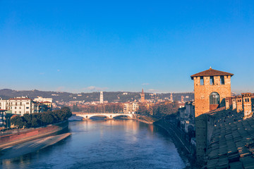 View from Castelvecchio castle of the Adige River and the bridge Ponte della Vittoria. Winter time, the beginning of the evening. Verona, italy