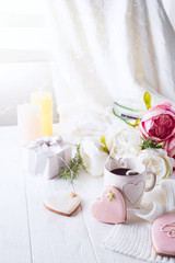 romantic breakfast in bed. Coffee , cookies ,gift box and flower on wooden table. Valentine's day concept
