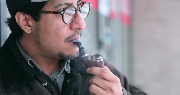 4K Footage of Retro style man wear glasses and smoke a pipe. - Video