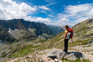 Young girl pointing to wonderful Tatra valley, High Tatras mountains, Slovakia