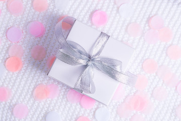 Beautiful gift box on white background with confetti.