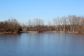 The calm water of the lake in the country on a sunny day.