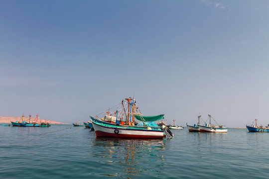 Colorful fishing boats anchored at the pier of Paracas, Peru