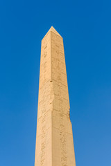 Granite obelisk against blue sky in a Karnak temple. Luxor, Egypt.