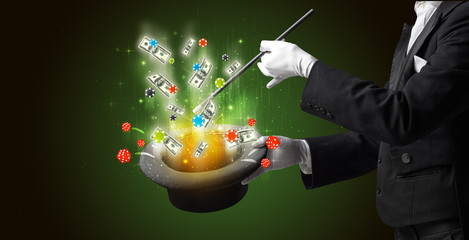 Illusionist conjure with magic wand gambling things from a cylinder