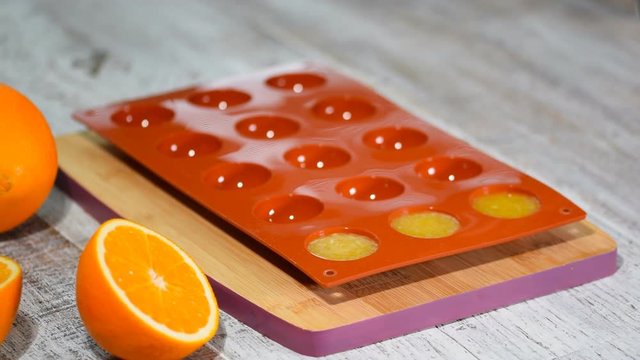 Pouring Orange Jelly In The Silicone Mold.