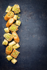 Traditional Oriental baklava collection as top view on a black board with copy space right