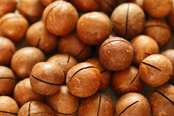 Ripe macadamia nuts scattered on the table.