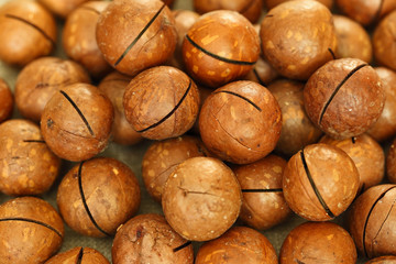 Ripe macadamia nuts scattered on the table.