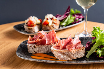 Sandwich with prosciutto, cheese and lettuce