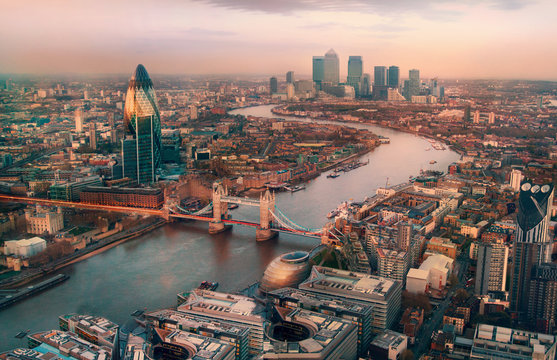 London view at sunset. Panorama include river Thames, Tower bridge and City of London and Canary Wharf  buildings.