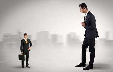 Giant businessman being afraid of small serious executor with suitcase
