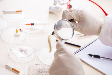 Young expert criminologist working in the lab 