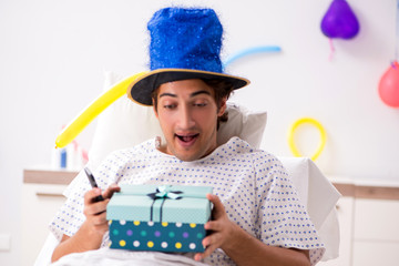 Fototapeta premium Young man celebrating his birthday in hospital