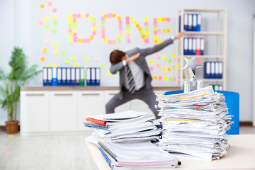 Young handsome employee sitting at the office 