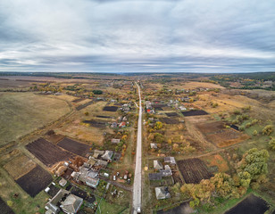 Russian sparsely populated village. Green meadows and dense shrubs. View from above.