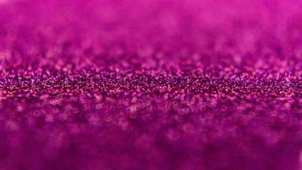 Glitter background in pink / purple / magenta color. Festive background. Small size particles. Magic glowing effect. Perfect for phone wallpaper, festive invitation or greeting card.