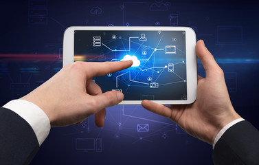 First person view of a hand using tablet with cloud office concept
