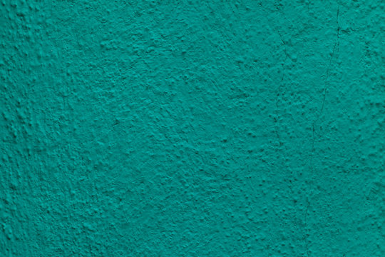 Emerald green painted stucco wall. Background texture.