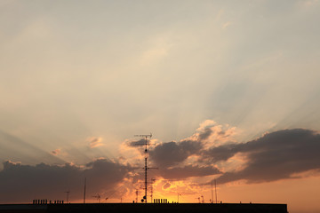 Television antennas on the roof pictured at sunset