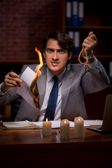 Businessman burning the evidence late in office