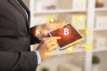Business woman using tablet with cryptocurrency bitcoin link network concept
