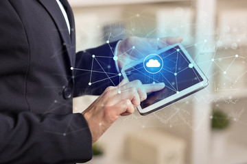 Business woman using tablet with financial, cloud connectivity concept