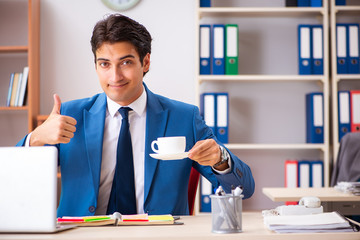 Young handsome businessman working in the office 