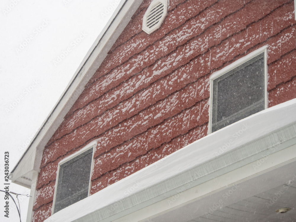 Wall mural facade detail of red house in the blizzard