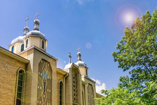 Ukrainian greek catholic church of the Epiphany and beautiful sky with sun glare. Rochester, USA