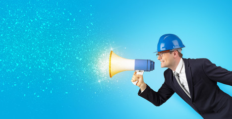 Fototapeta premium Young architect constructor yelling with megaphone and sparkling sounds 