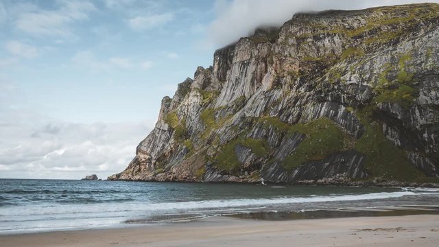 4k Timelapse movie film clip of Bunes sand beach with view to Bunes Fjorden at Lofoten Islands in Norway on a blue sky with clouds sunny day.