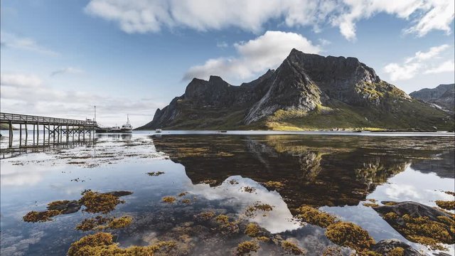 4k Timelapse movie film clip of Bunes sand beach with view to Bunes Fjorden at Lofoten Islands in Norway on a blue sky with clouds sunny day.
