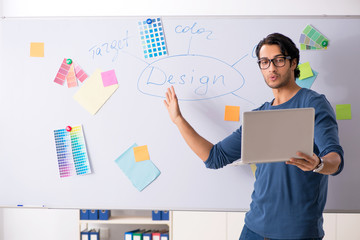 Young handsome designer working at the project  