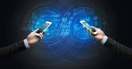 Close up of two smartphones syncing business data