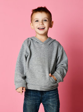 Young baby boy kid in grey hoodie  with free text copy space happy