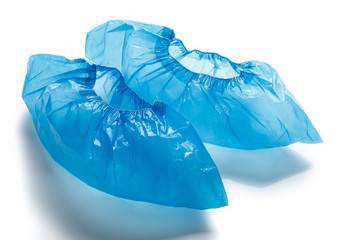 Two blue medical Shoe covers for feet isolated on white background. Hygiene and cleanliness in health facilities