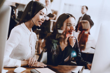 Two Young Smiling Women Working in Call Center.