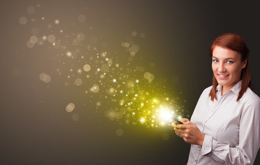 Person using phone with gold sparkling concept
