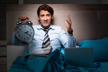 Tired businessman working overtime at home at night