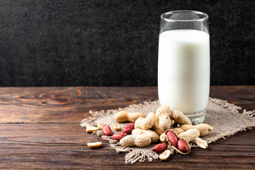 Peanut milk on wooden background background.