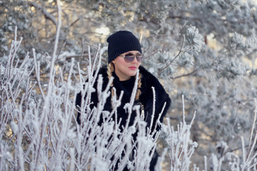 Beauty fashion portrait. Smiling young woman on winter background.