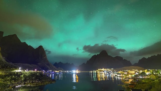 4k Timelapse movie film clip of Northern Lights Aurora Borealis with classic view of the fisherman s village of Reine, near Hamnoyin Norway, Lofoten islands. This shot is powered by a wonderful